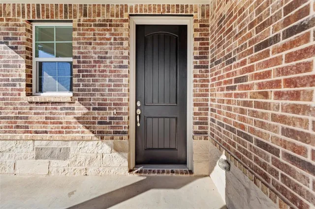 a view of a door and brick wall
