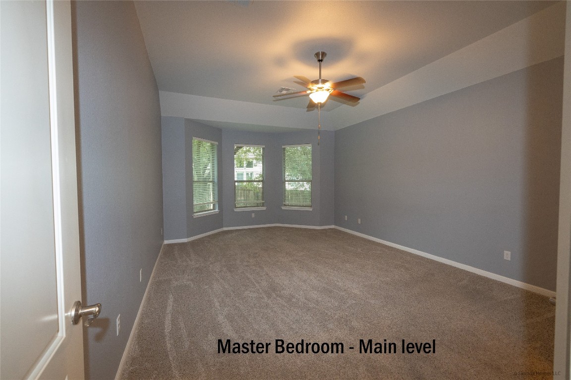 104 Palisades Cove Austin, TX 78732 - Photo 11 of 27 Carpeted spare room with baseboards and ceiling fan