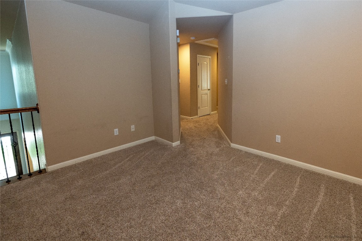 104 Palisades Cove Austin, TX 78732 - Photo 19 of 27 Carpeted empty room with baseboards