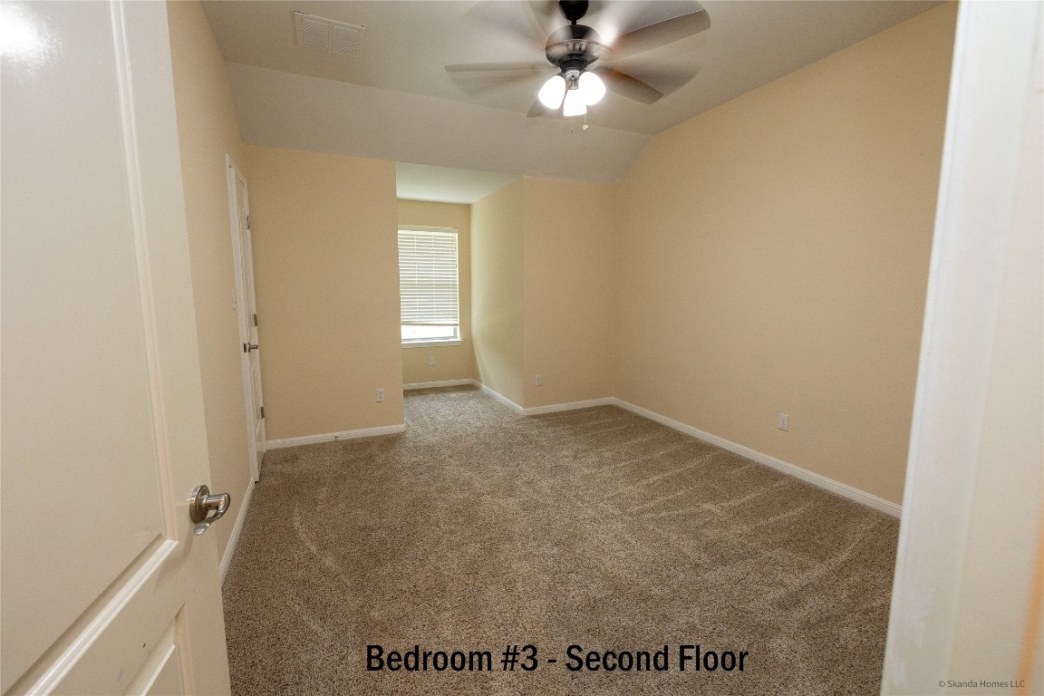 104 Palisades Cove Austin, TX 78732 - Photo 22 of 27 Unfurnished room with carpet flooring, a ceiling fan, and vaulted ceiling
