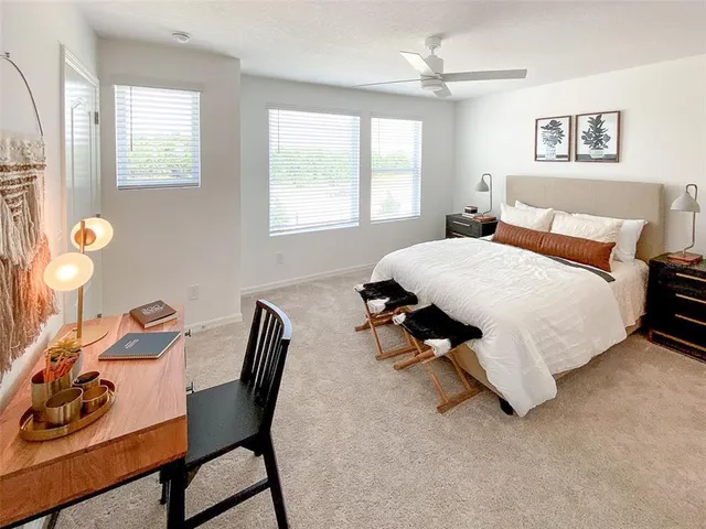 a bedroom with a bed and a window