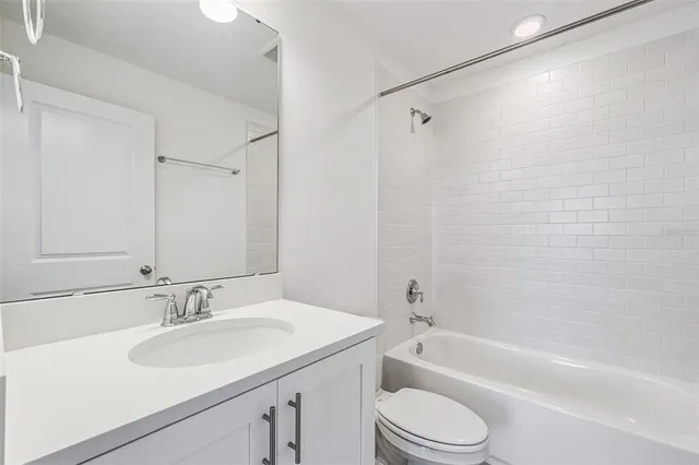 a bathroom with a sink toilet vanity and shower