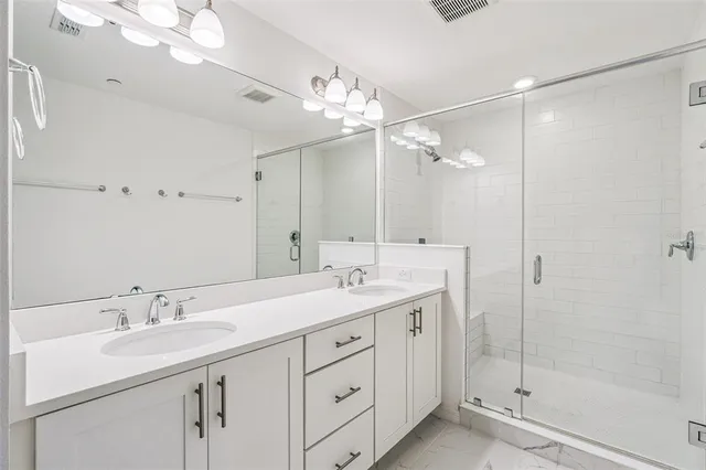 a bathroom with a sink double vanity and a mirror