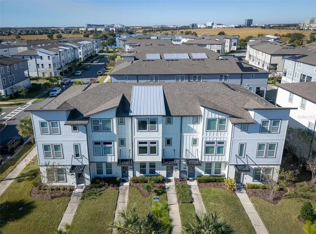 an aerial view of a residential apartment building with a yard