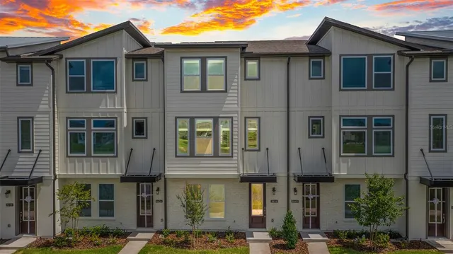 a front view of a residential apartment building with a yard