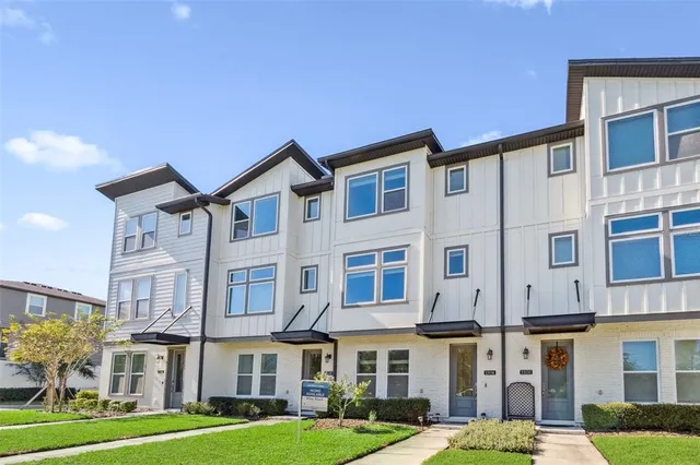 a front view of a building with a yard