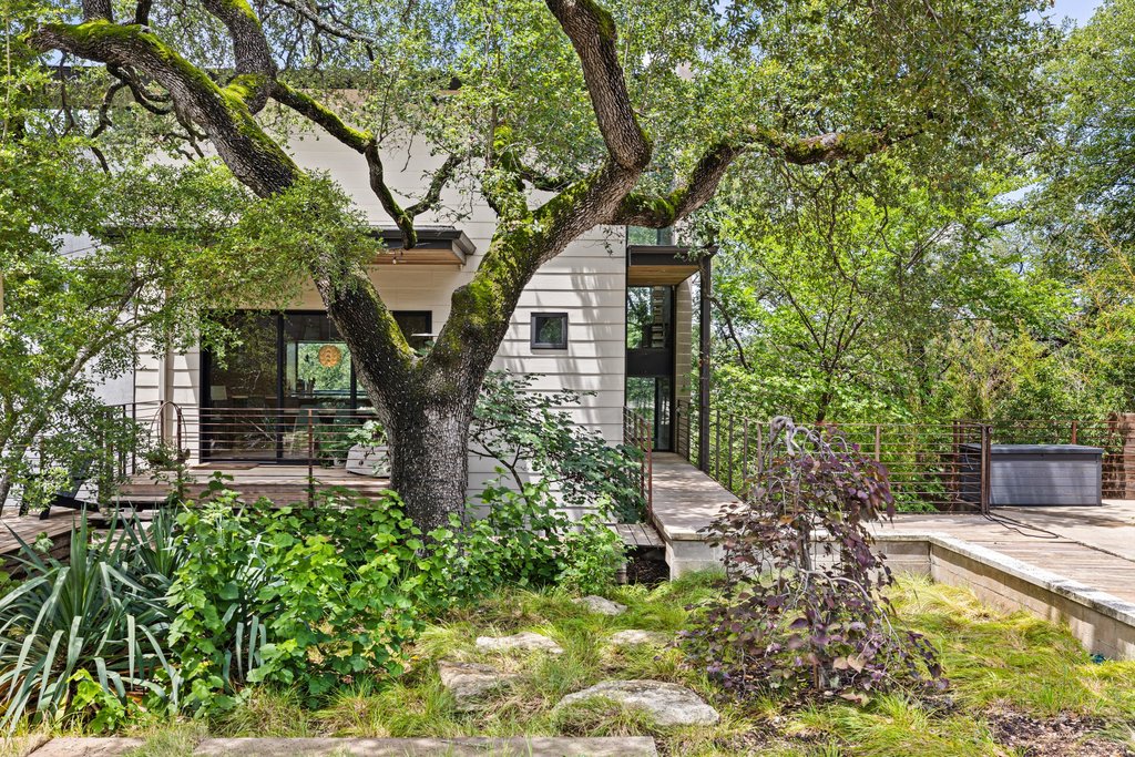 801 The High Road Austin, TX 78746 - Photo 39 of 40 a front view of a house with garden