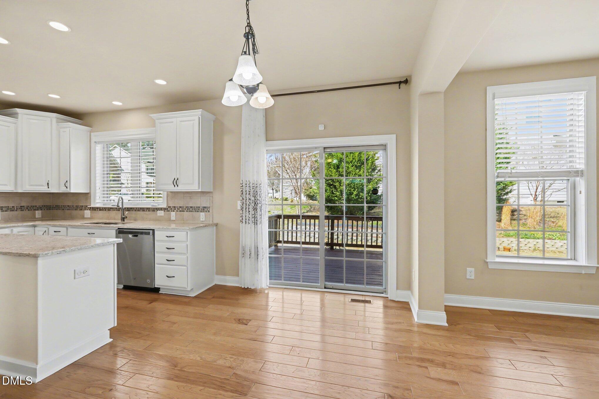351 Gartrell Way Cary, NC 27519 - Photo 21 of 51 a open kitchen with granite countertop a stove top oven a sink and wooden floors