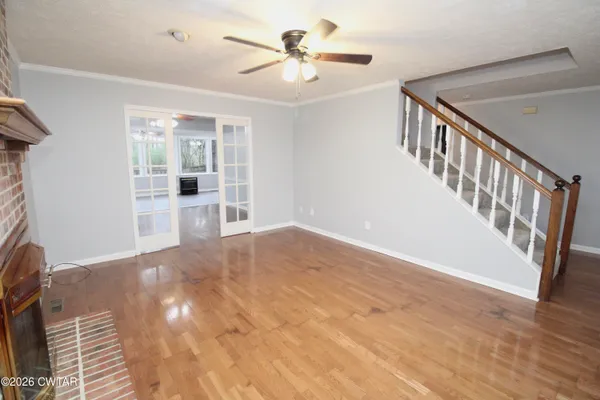 a view of empty room with wooden floor