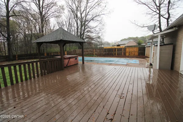 a view of backyard with a deck and wooden floor