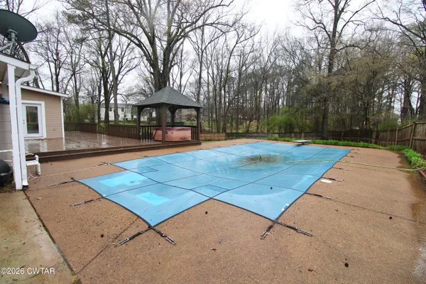 a view of a swimming pool with an outdoor space and seating area
