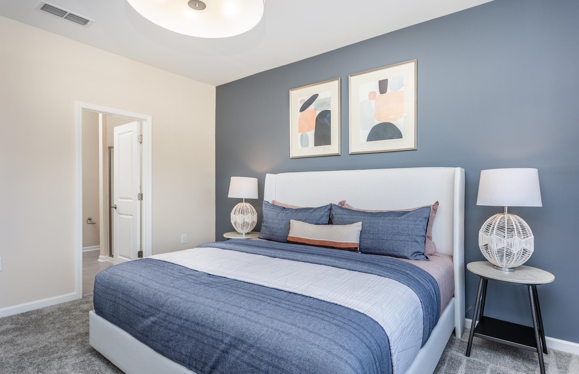 3521 New Town Road Raleigh, NC 27604 - Photo 11 of 18 a bedroom with a bed and a lamp on table