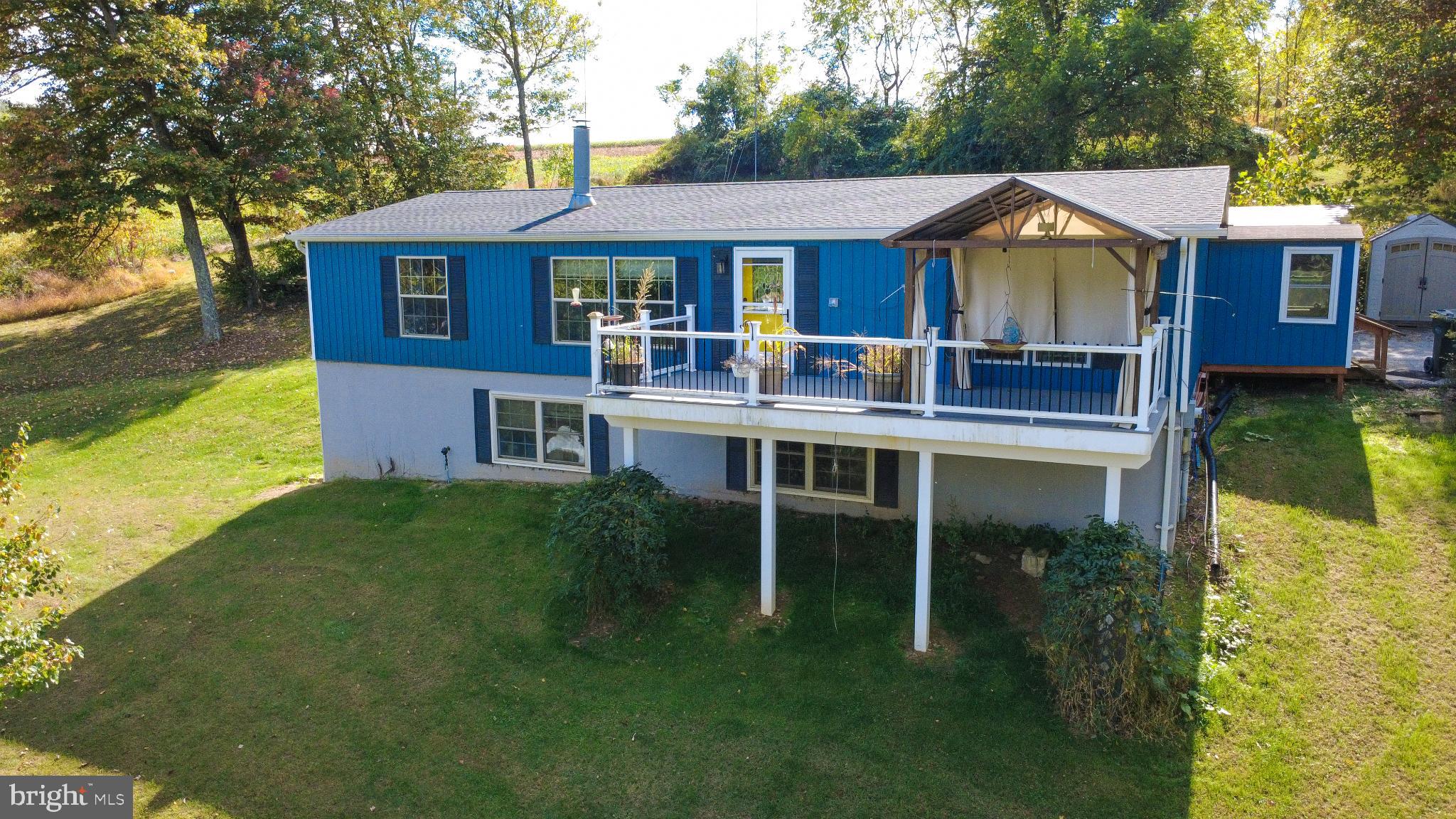 15792 Cross Mill Road Felton, PA 17322 - Photo 1 of 33 a front view of a house with a yard table and chairs