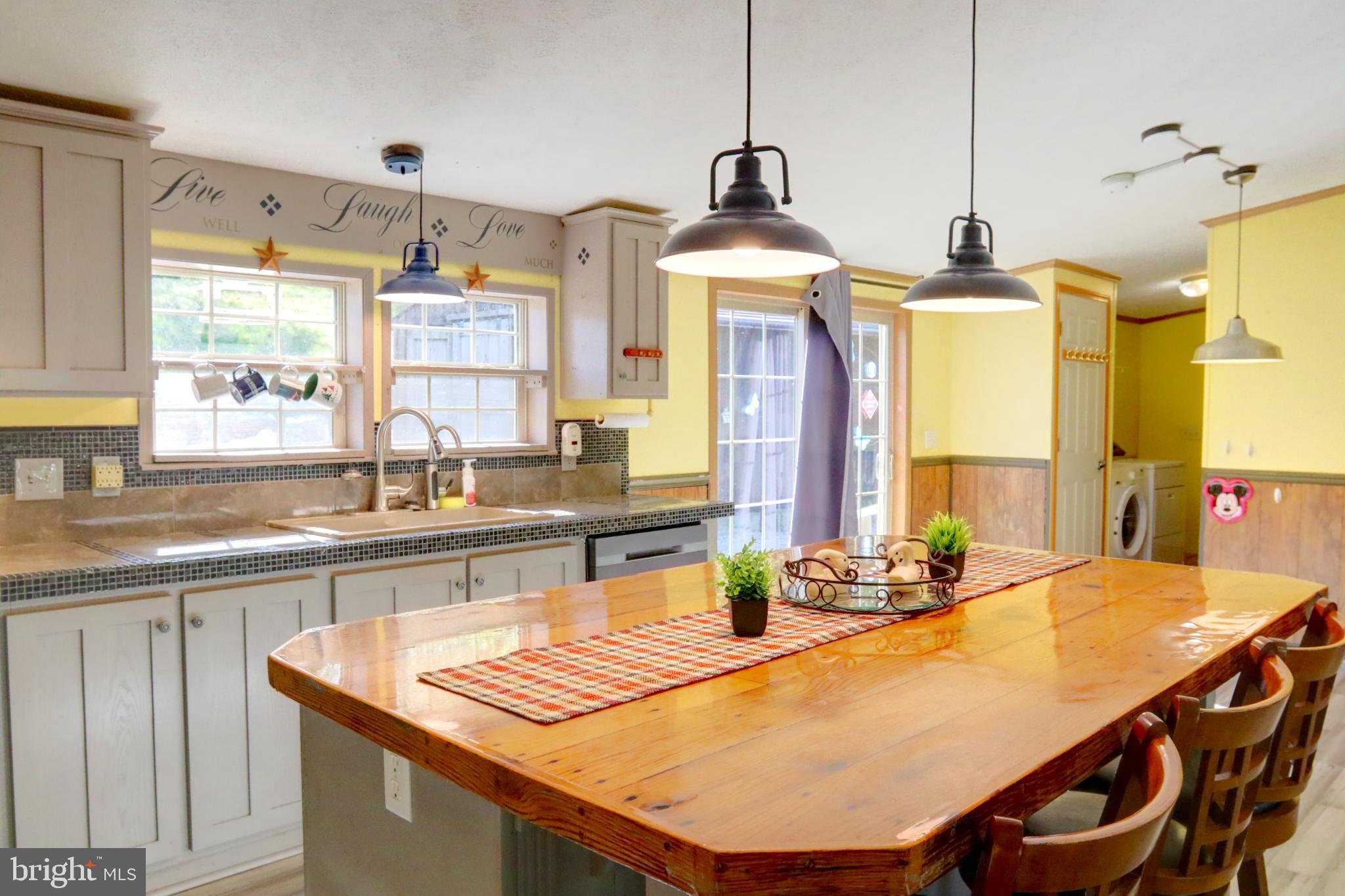 15792 Cross Mill Road Felton, PA 17322 - Photo 12 of 33 a kitchen with stainless steel appliances granite countertop a sink a stove and a wooden floors