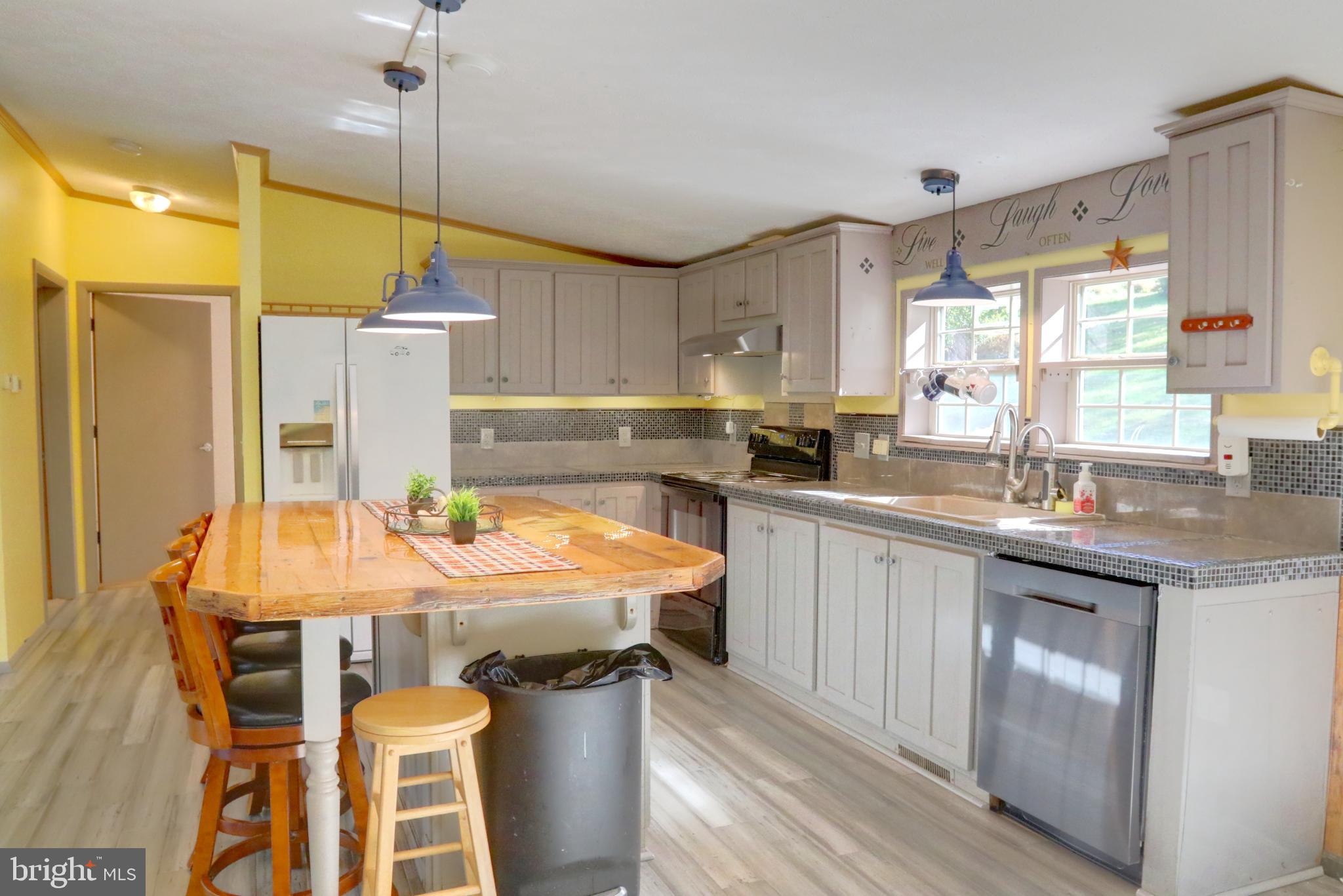 15792 Cross Mill Road Felton, PA 17322 - Photo 13 of 33 a kitchen with a table chairs sink and cabinets