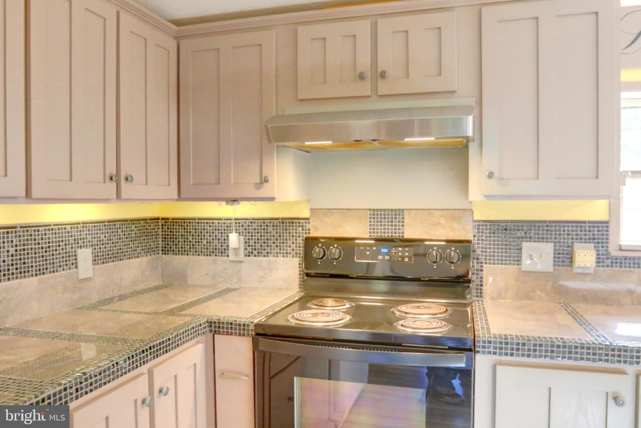 15792 Cross Mill Road Felton, PA 17322 - Photo 17 of 33 a kitchen with granite countertop a sink a stove and cabinets