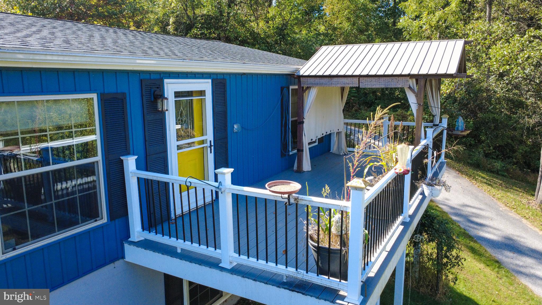 15792 Cross Mill Road Felton, PA 17322 - Photo 8 of 33 a view of a wooden deck and a patio with fire pit