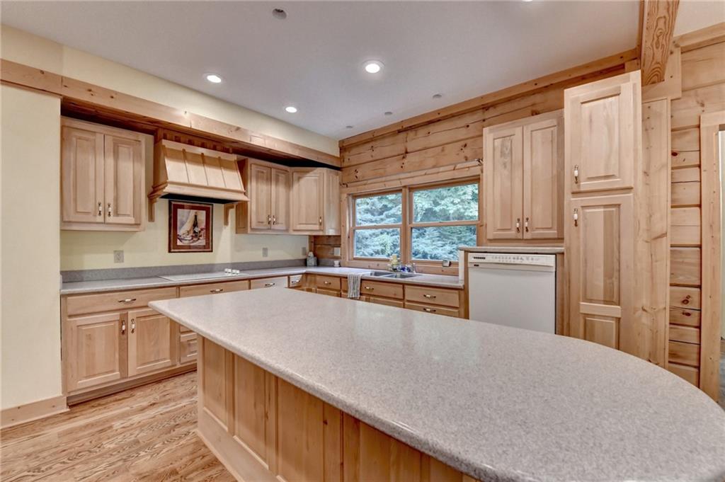 82 Walnut Grove Lane Tiger, GA 30576 - Photo 18 of 88 a kitchen with stainless steel appliances granite countertop a refrigerator a sink dishwasher a stove and white countertops with wooden floor
