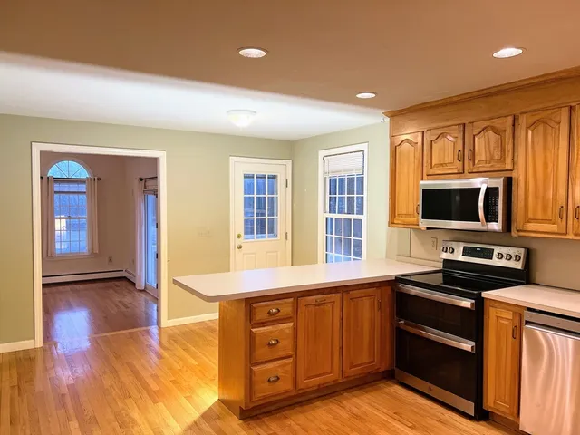 a kitchen with stainless steel appliances granite countertop a refrigerator and a sink