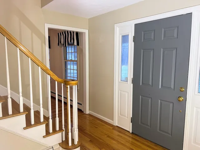 a view of empty room with window and cabinet