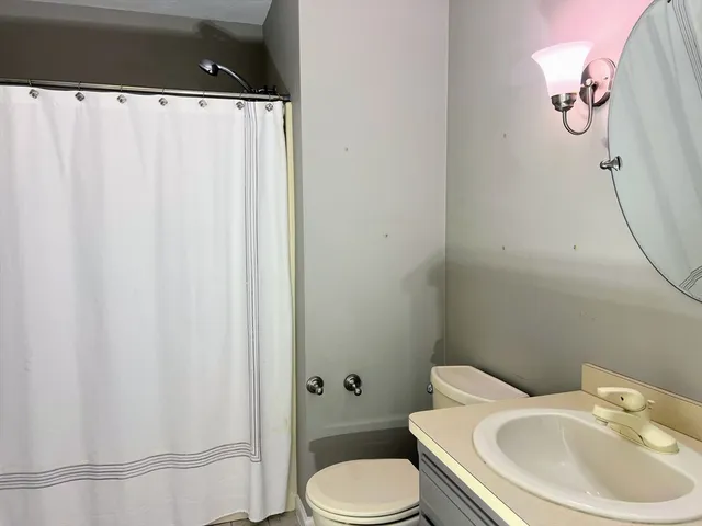 a view of staircase with railing and a chandelier