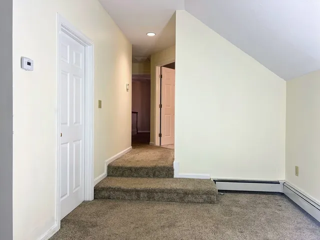 a view of a house with a yard covered in snow