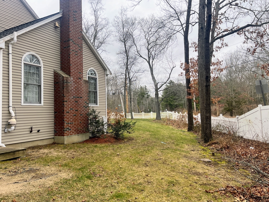 1565 West Street Wrentham, MA 02093 - Photo 36 of 41 a backyard of a house with lots of green space