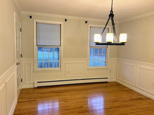 a view of a room with wooden floor and windows