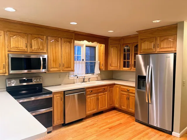 a kitchen with stainless steel appliances granite countertop a stove and a sink