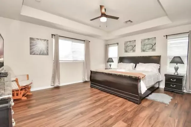 a bedroom with a bed and wooden floor