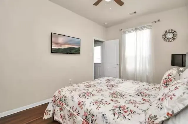 a bedroom with a bed and a flat screen tv