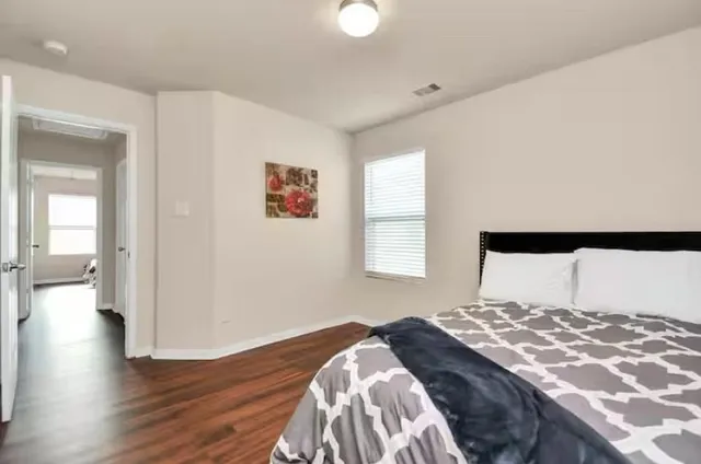 a bedroom with a bed and a window