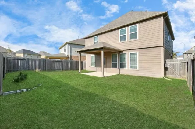 a view of a house with a backyard