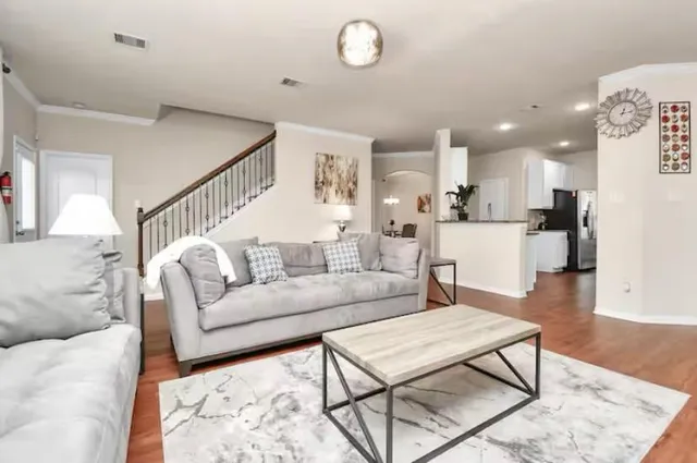 a living room with furniture and kitchen view