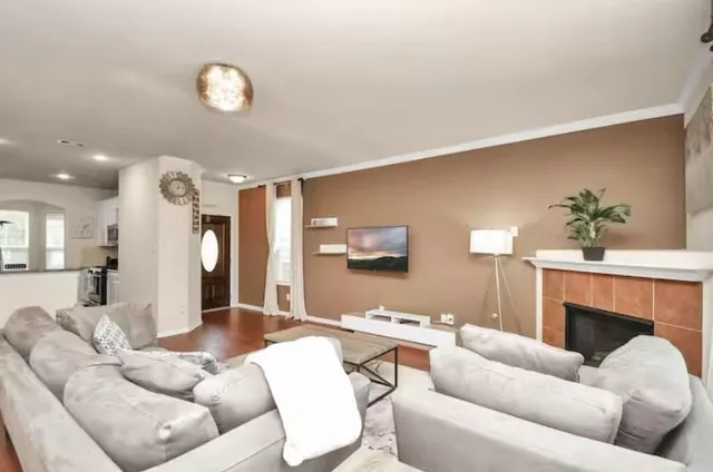 a living room with furniture and a fireplace