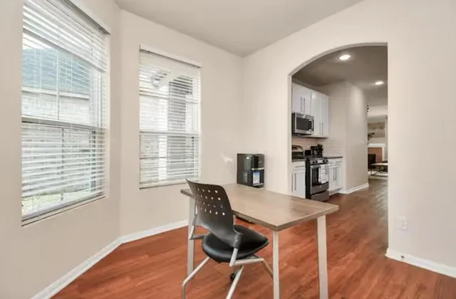 a view of a dining room with furniture and windows