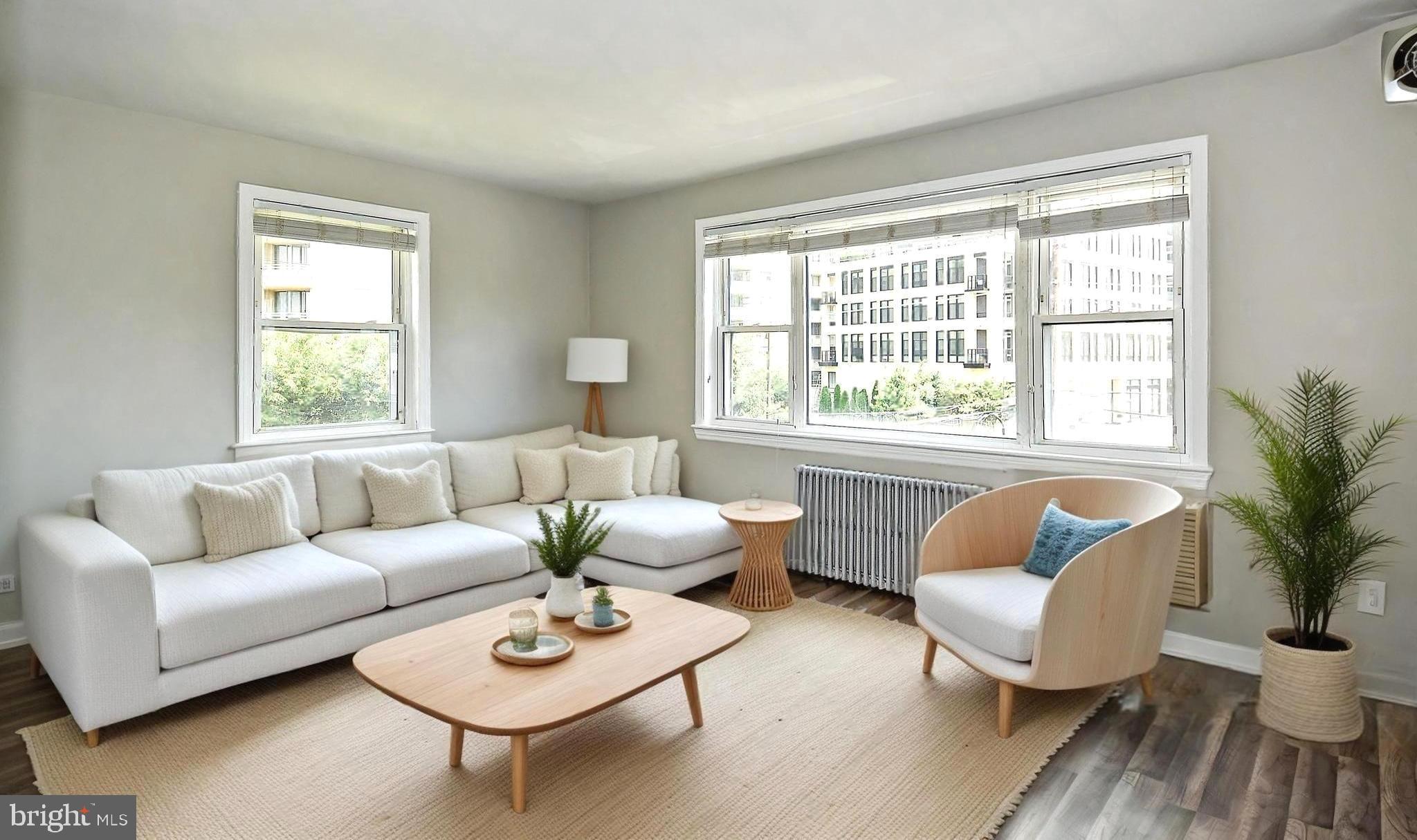 7036 Strathmore Street, Unit 311 Chevy Chase, MD 20815 - Photo 1 of 16 a living room with furniture and a large window