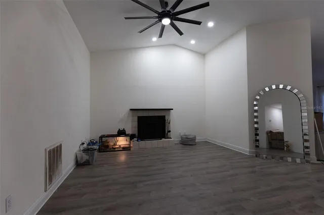 wooden floor in an empty room with a fireplace