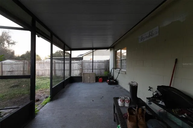 a view of a room with wooden floor and iron stairs
