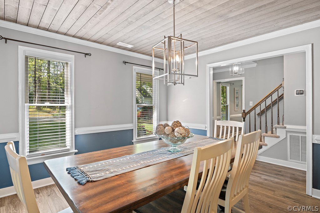 13906 Turtle Hill Road Midlothian, VA 23112 - Photo 27 of 35 a view of a dining room and livingroom with furniture wooden floor a chandelier
