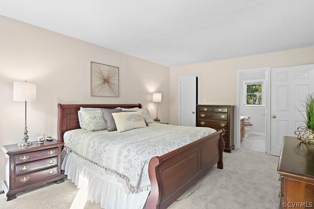 13906 Turtle Hill Road Midlothian, VA 23112 - Photo 30 of 35 a spacious bedroom with a bed and a lamp