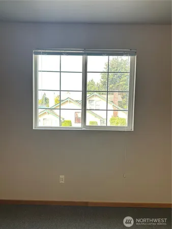 a view of a glass door with a tree in the background