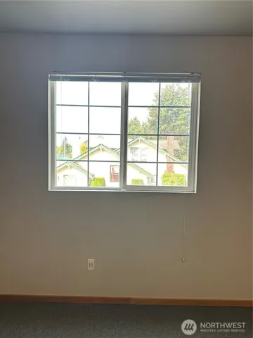 a view of a glass door with a tree in the background