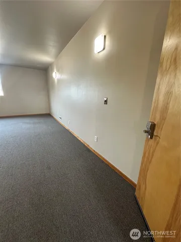 an empty room with a wooden door