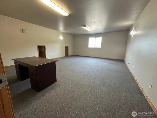 a view of a big room with windows and cabinet