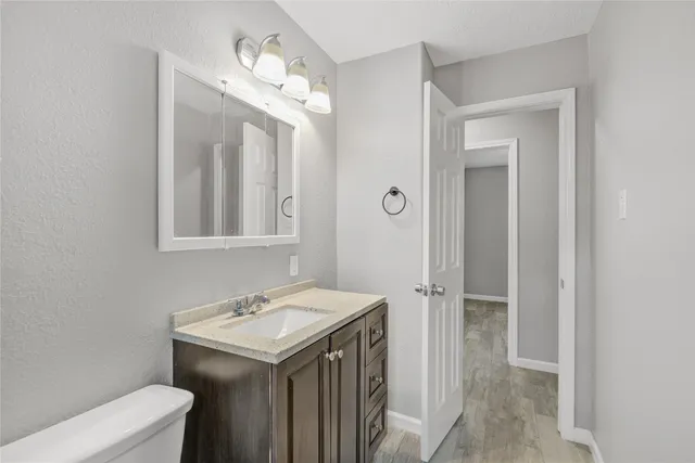 a bathroom with a sink a toilet and a mirror