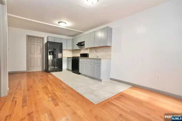 a kitchen with a refrigerator and a sink