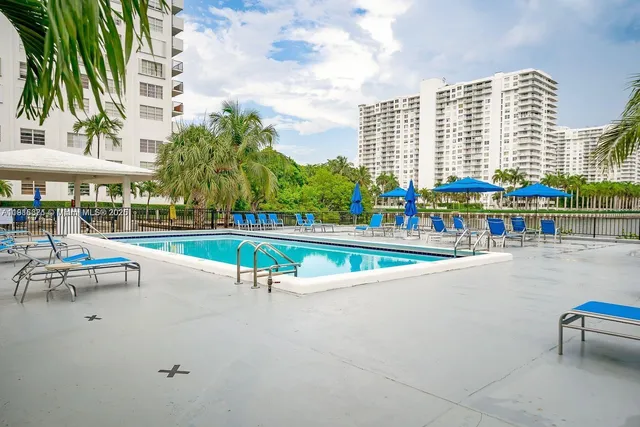 a view of swimming pool with outdoor seating and a tub