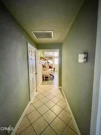 a view of a hallway with wooden floor and furniture