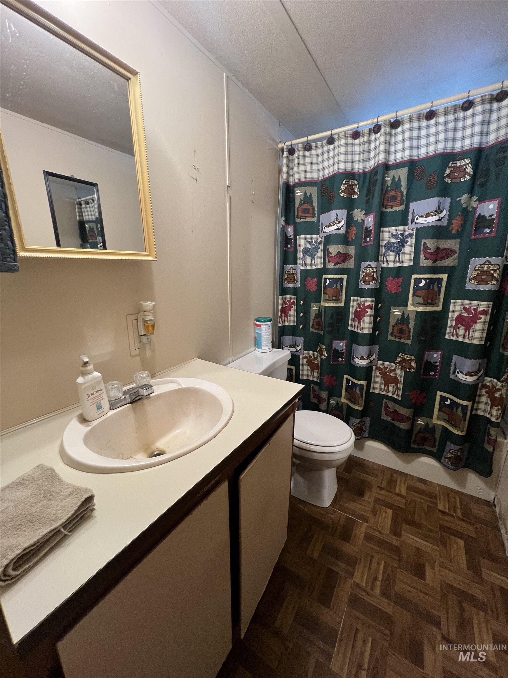 23743 Stephen Lane Parma, ID 83660 - Photo 31 of 34 Bathroom with a textured ceiling, vanity, and parquet flooring